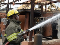 Fire fighters put out fire at the scene of gas explosion in Bauwa, Lagos on Thursday. Gas explosion from Best Roof Cooking Gas Station kille...