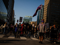 Protestors stop while marching down to hold a round dance before continuing their march down University Avenue demanding an end to the crimi...