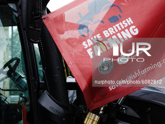 A 'Save British Farming' banner hangs from a tractor parked in protest outside the Houses of Parliament in London, England, on October 12, 2...