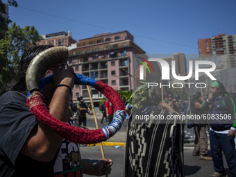 A person plays an aerial instrument of name -TRUTRUKA-, coming from the ancestral nation-people Los Mapuche  during a protest in the framewo...
