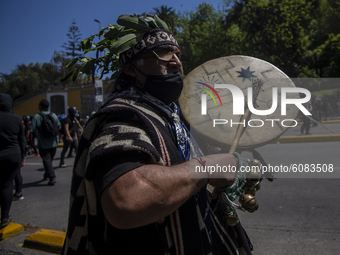 A person plays a percussion instrument - KULTRUN-, (typical instrument of the Mapuche people-nation)  during a protest in the framework of t...