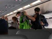 Passengers with facemasks while boarding in the cabin. Flying with Lauda Airbus A320 airplane with registration 9H-LMJ during the Covid-19 C...