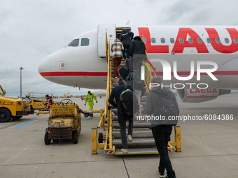 Passengers boarding in the plane for the flight in Vienna. Flying with Lauda Airbus A320 airplane with registration 9H-LMJ during the Covid-...