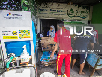 Residents bring inorganic waste to the Bank Sampah (Garbage Bank) Guyub Rukun to exchange money or groceries such as rice and sugar in Kemij...