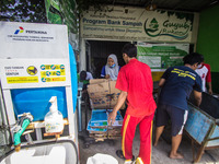 Residents bring inorganic waste to the Bank Sampah (Garbage Bank) Guyub Rukun to exchange money or groceries such as rice and sugar in Kemij...