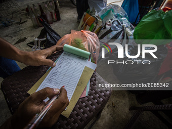 A man records on Bank Sampah saving book at the Bank Sampah Guyub Rukun in Kemijen Sub-district, Semarang, Central Java Province, Indonesia...