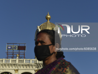 A woman wears a mask with a dome of a building over her head amid coronavirus emergency in Kolkata, India, 13 October, 2020. India's coronav...