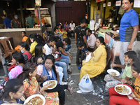 People eat fast food without maintaining social distancing in front of a fast food outlet amid coronavirus emergency in Kolkata, India, 13 O...