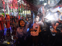 Student Union of Thailand president, Jutatip Sirikhan holds up finger salute outside the Royal Thai Police Headquarters to protest the earli...
