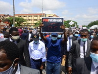 The Lagos State Governor (Centre) display ENDSARS in a placard in a crowd showing his support of the ongoing protest against the harassment,...
