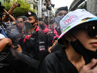 Pro-democracy protesters confront police officers at Ratchaprasong interjection central of Bangkok near Royal Thai Police Headquarter on Oct...