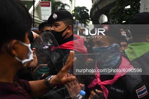 Pro-democracy protesters combat police officers during a rally at Ratchaprasong interjection central of Bangkok near Royal Thai Police Headq...
