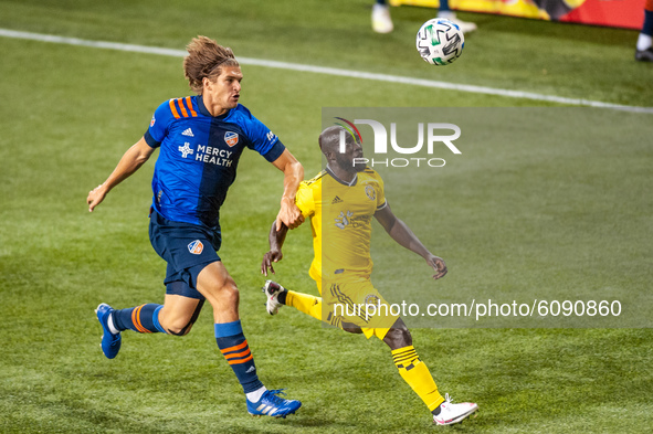 Cincinnati defender, Nick Hagglund, and Columbus midfielder, Emmanuel Boateng, compete for the ball during an MLS soccer match between FC Ci...