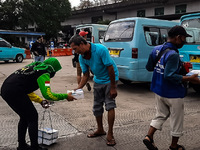 Volunteers distribute lunch for transport drivers at the Kampung Melayu terminal, Jakarta, Indonesia, on October, 16, 2020. The food is dist...