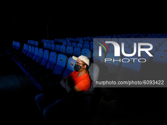 A gentleman watching movie at a cinema hall in Kolkata, India, on October 16, 2020. Cinema halls are permitted to open with 50 % audience ca...