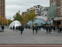 Partial lockdown and daily life in Eindhoven city in the Netherlands with people wearing facemask as they are outside walking or on the bicy...