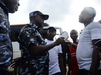 A Youth of End Sars Protesters exchange words with a police man following the barricade of Lagos - Ibadan expressway, the oldest highway and...