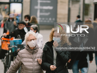 shoppers with face mask are seen in the shopping block in Duesseldorf, Germany, on October 16, 2020 amid the COVID-19 pandemic. (