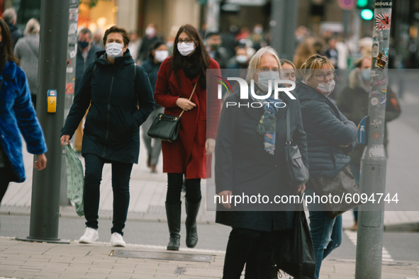 shoppers with face mask are seen in the shopping block in Duesseldorf, Germany, on October 16, 2020 amid the COVID-19 pandemic. 