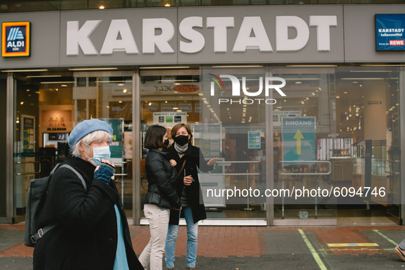 people with face masks are seen in front of Karstadt in Duesseldorf, Germany, on October 16, 2020 amid the COVID-19 pandemic. 