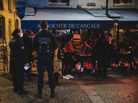 In the rue Montorgueil, police officers are patrolling to check that restaurants and brasseries are indeed starting to close as the curfew i...