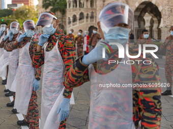 Firefighters wearing face shield warm up before a disinfection process begin in Kuala Lumpur, Malaysia, on  October 17, 2020. Malaysias capi...