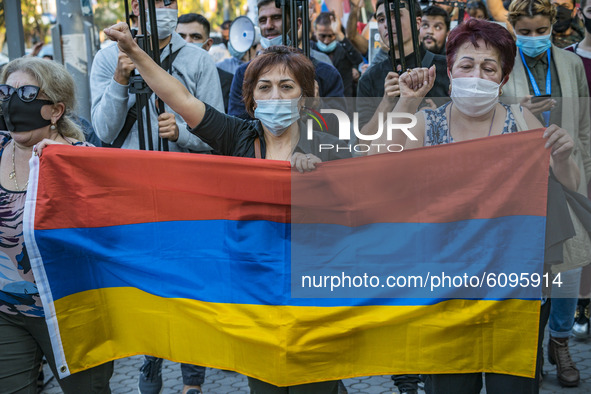 Protesters with an armenian flag in the front of a demonstration in Yerevan, Armenia, on October 16, 2020 for the recognition of Nagorno Kar...