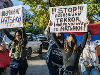 Protesters hold banners asking for stopping the conflict in Karabakh during a demonstration in Yerevan, Armenia, on October 16, 2020 for the...