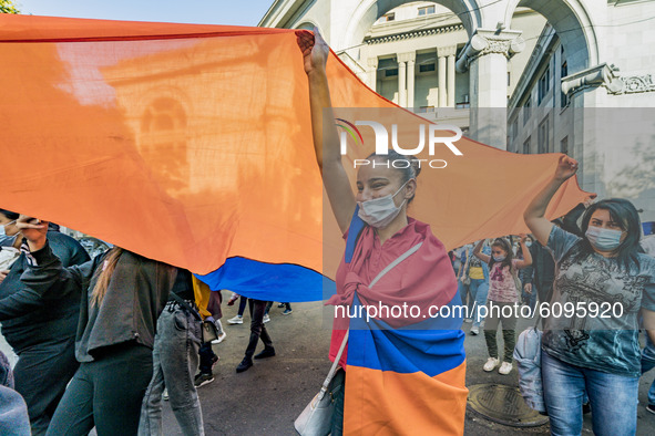 A girl holds a huge armenian flag during a demonstration in Yerevan, Armenia, on October 16, 2020 for the recognition of Nagorno Karabakh as...
