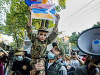 A kid holds a Karabakh flag during a demonstration in Yerevan, Armenia, on October 16, 2020 for the recognition of Nagorno Karabakh as an in...