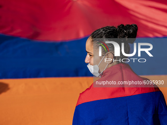 A girl with an armenian flag as a cape during a demonstration in Yerevan, Armenia, on October 16, 2020 for the recognition of Nagorno Karaba...