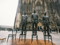 Statues of Edward Snowden, Julian Assangen and Chelsea Manning is seen in front of Dom cathedral in Cologne, Germany, on October 17, 2020. (