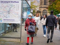 A woman wears a face mask in the city center of Sheffield, England  on 17 October 2020. (