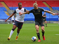  Boltons Nathan clashes with Oldhams Carl Piergianni during the Sky Bet League 2 match between Bolton Wanderers and Oldham Athletic at the R...