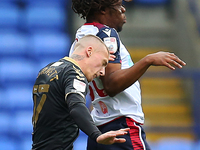  Boltons Peter Kioso clashes with Oldhams Jordan Bernett during the Sky Bet League 2 match between Bolton Wanderers and Oldham Athletic at t...