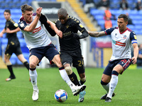 Bolton Wanderers' Ryan Delaney and Antoni Sarcevic and Oldham Athletic's Dylan Bahamboula in action during the Sky Bet League 2 match betwee...