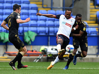 Bolton Wanderers' Nathan Delfouneso ands Oldham Athletic's Brice Ntambwe in action during the Sky Bet League 2 match between Bolton Wanderer...