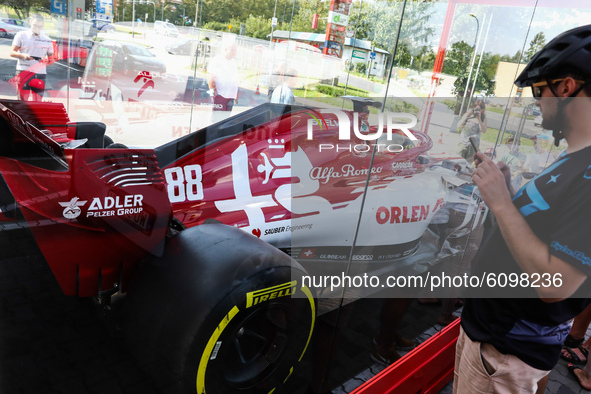 Formula 1 car Sauber C-37 in the livery of Alfa Romeo Racing-Ferrari is seen in the showcase at a gas station in Krakow, Poland on September...