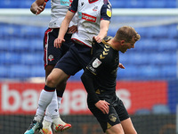  Boltons Peter Kioso & Harry Brockbank clash with Oldhams Jordan Barnett during the Sky Bet League 2 match between Bolton Wanderers and Oldh...