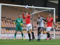 Tylor Golden of Salford City with a defensive header with Cristian Montao of Port Vale attackinigduring the Sky Bet League 2 match between P...