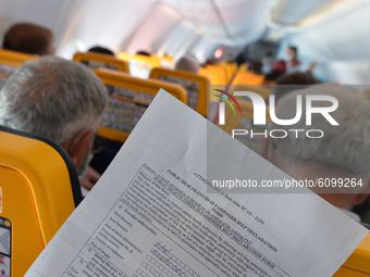 Public Health Covid-19 Passenger Self Declaration Form hold by a passenger inside a Ryanair plane at Burgas airport.
The number of people in...