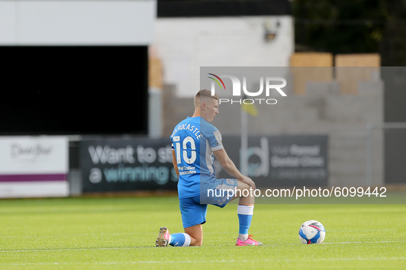 Barrow's Lewis Hardcastle takes the  knee during the Sky Bet League 2 match between Harrogate Town and Barrow at Wetherby Road, Harrogate, E...