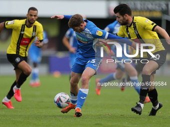 Barrow's Luke James battles for possession with Harrogate Town's  Connor Hall during the Sky Bet League 2 match between Harrogate Town and B...