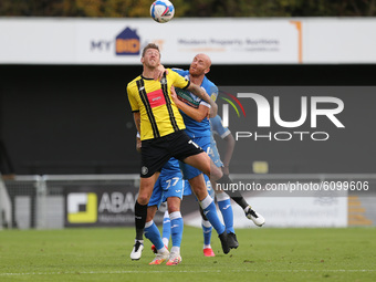 Jason Taylor of Barrow contests a header with Harrogate Town's  Jonathan Stead during the Sky Bet League 2 match between Harrogate Town and...