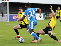 Barrow's Kgosi Ntlhe in action with Harrogate Town's  George Thomson and Ryan Fallowfield  during the Sky Bet League 2 match between Harroga...