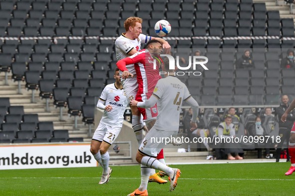 Milton Keynes Dons captain Dean Lewington heads the ball clear during the first half of the Sky Bet League One match between MK Dons and Gil...