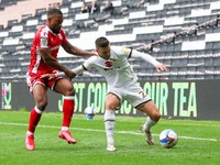 Milton Keynes Dons Daniel Harvie is challenged by Gillingham's Ryan Jackson during the second half of the Sky Bet League One match between M...