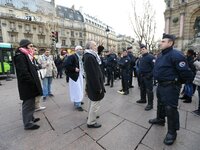 This picture taken on December 29, 2012, in Paris, shows the President of the Cheikh Yassine collective Abdelhakim Sefrioui (C with a white...