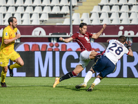 Lyanco of Torino FC and Alessio Cragno of Caglieri during the Serie A football match between Torino FC and Cagliari Calcio at Olympic Grande...