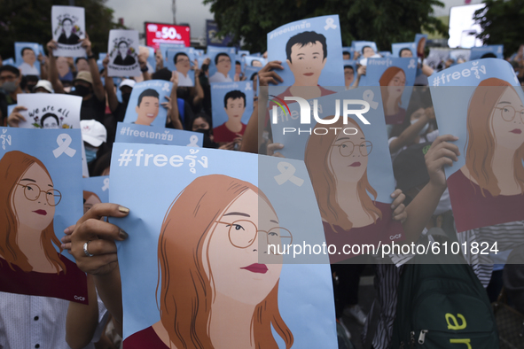 Thai protesters hold hold up posters of protest leaders who have been arrested during an anti-government protest at the Victory Monument in...